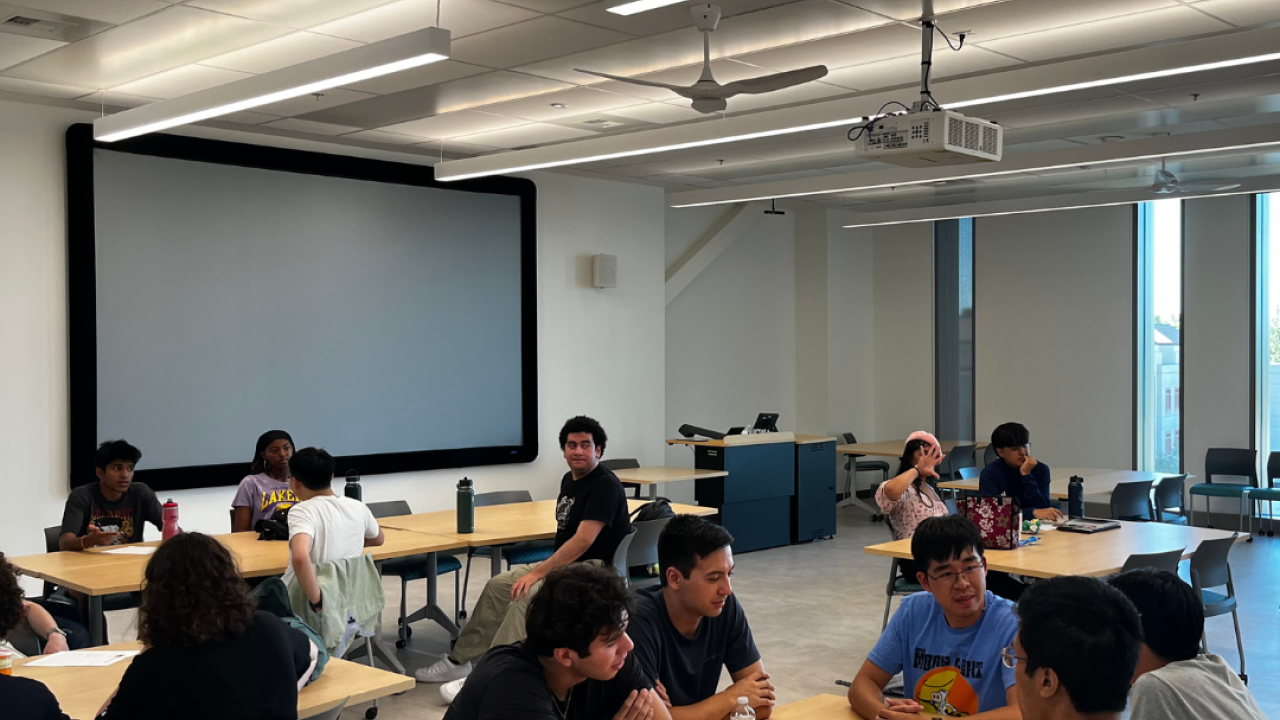 Summer sessions students sitting in groups playing trivia.